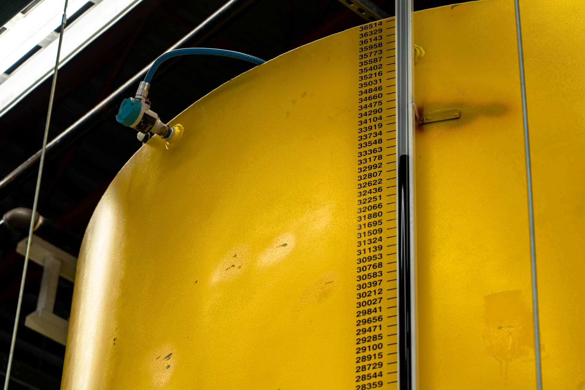 Large yellow storage tank with volume gauge at Consolidated Biofuels facility